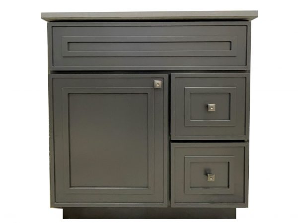 Gray-green bathroom vanity cabinet with stone countertop, one horizontal drawer at top, one large cabinet door on left, and two drawers stacked on right side with square handles