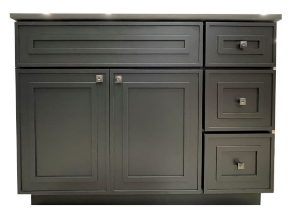 Dark gray bathroom vanity with asymmetrical design featuring two large cabinet doors on left, one drawer above, and three drawers on right side