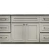 Light gray bathroom vanity with six drawers surrounding two central cabinet doors and black countertop