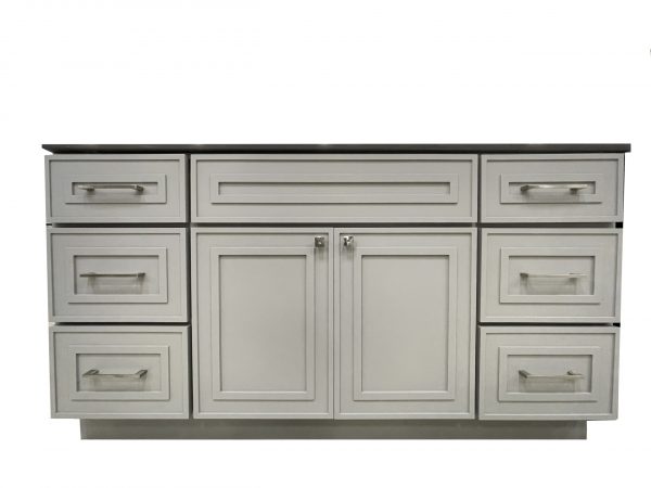 Light gray bathroom vanity with six drawers surrounding two central cabinet doors and black countertop