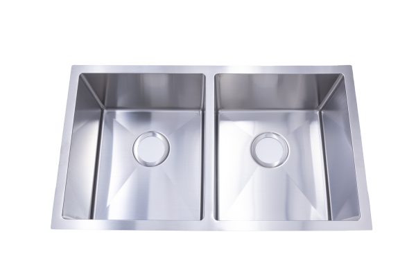 Stainless steel double bowl undermount kitchen sink with two spacious rectangular basins featuring angled sidewalls and drain holes