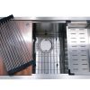 Stainless steel kitchen sink with multiple compartments including cutting board, colander, and strainer basket with accessories