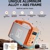 Orange and white portable power station on rocky surface showing aluminum alloy TB600 frame with fire retardant, corrosion resistant, lightweight, exceptionally hard, and superior heat dissipative properties compared to plastic body competitors