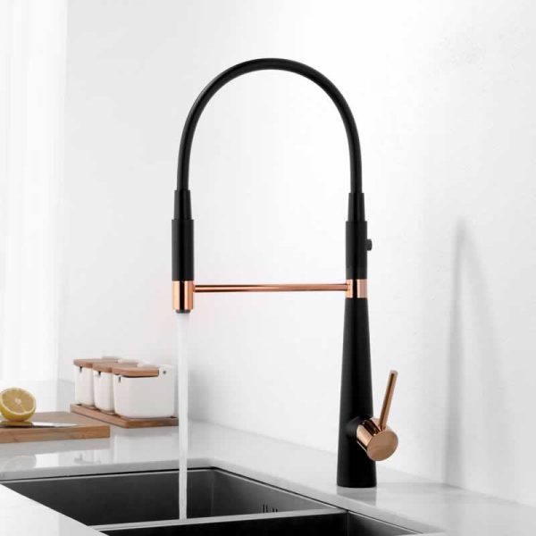 Modern black and rose gold kitchen faucet with pulldown sprayer and arched spout above black sink