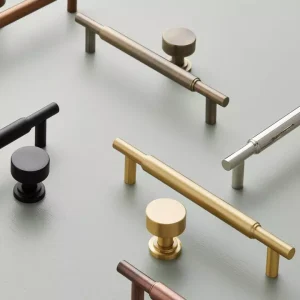 Collection of modern cabinet hardware including bar pulls and knobs in various finishes such as black, brass, and brushed nickel