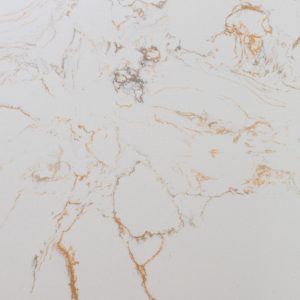 White marble surface with gold and tan veining and natural cracks