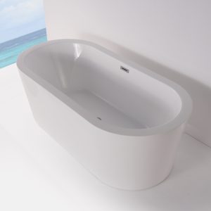 Close-up of white freestanding soaking tub with overflow drain next to ocean view window