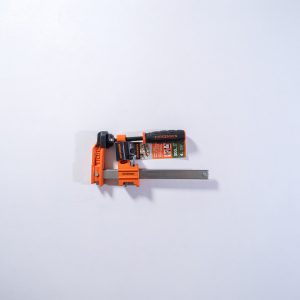 Jorgensen orange pipe clamp with gray metal bar and packaging visible