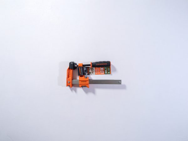 Jorgensen orange pipe clamp with gray metal bar and packaging visible