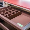 Pink drawer organizer with compartmentalized dividers for jewelry and accessories storage