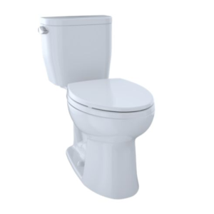 White two-piece toilet with closed lid and tank, viewed from a side angle
