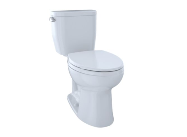White two-piece toilet with closed lid and tank, viewed from a side angle