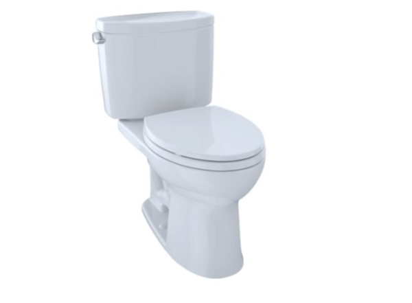 White two-piece toilet with closed lid and tank, viewed from a slight angle