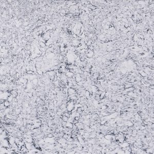 White and gray speckled granite or terrazzo surface with black flecks and granular texture