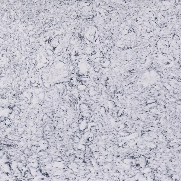 White and gray speckled granite or terrazzo surface with black flecks and granular texture