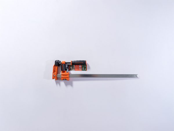 Jorgensen orange pipe clamp with metal bar shown from top view angle