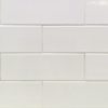 Cream and white subway tiles arranged in stacked horizontal brick pattern with beveled edges