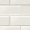 White subway tile backsplash with light gray grout lines in mixed brick pattern