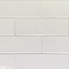White subway tiles with light gray grout in stacked brick pattern