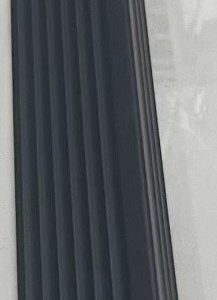 Dark gray composite fence panel with vertical ridged texture and metal corner bracket