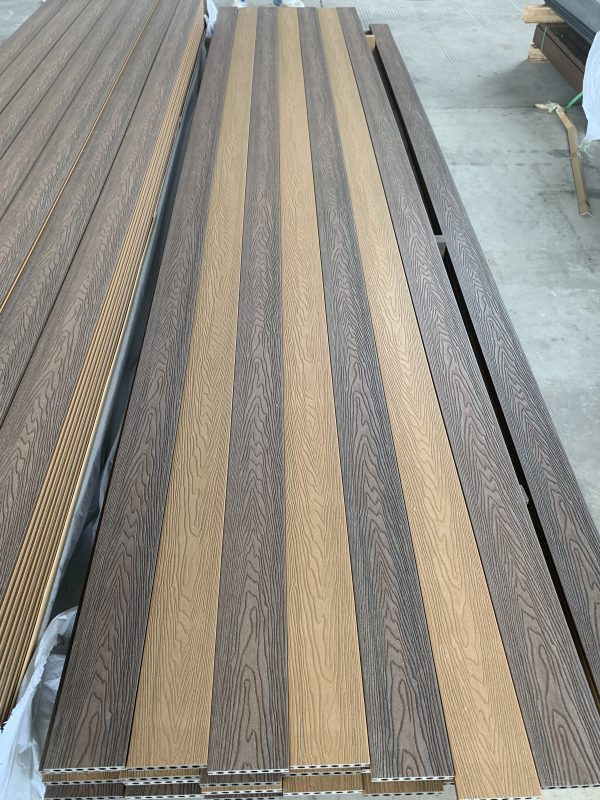 Multiple rows of engineered wood flooring boards in alternating light and dark gray oak finishes