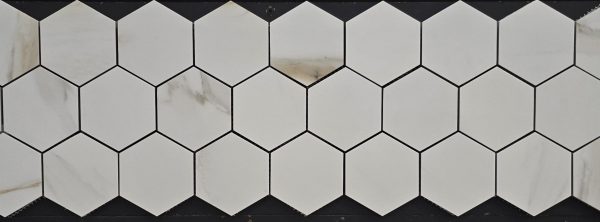 White marble hexagon tiles with subtle gray veining in honeycomb arrangement with dark grout lines