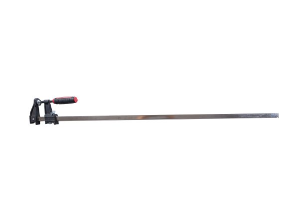 Heavy-duty bar clamp with black metal frame, red and black cushioned handle, and long steel bar for woodworking and construction