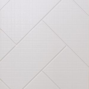 Close-up of white subway tiles arranged in large-scale herringbone pattern with subtle beveled edges