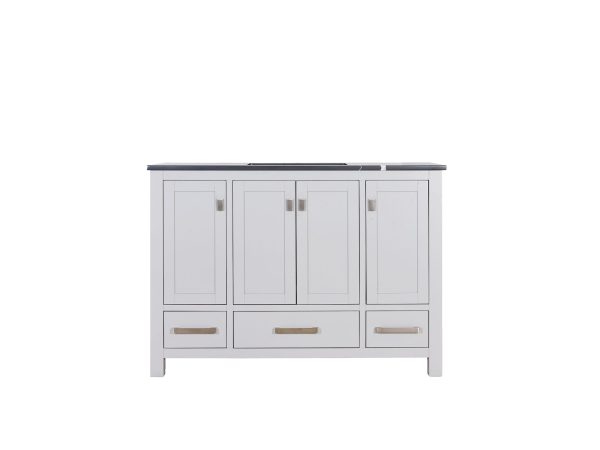 Light gray vanity cabinet with four cabinet doors on top and three drawers below with dark countertop