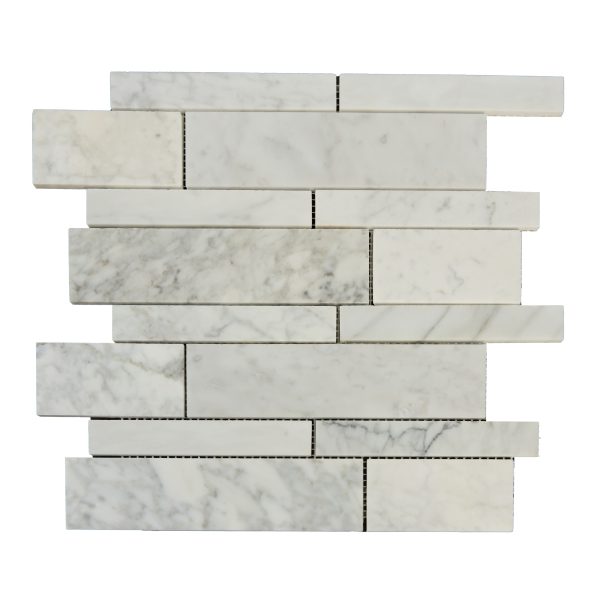 Carrara marble subway tiles in a stacked brick layout pattern with dark grout lines