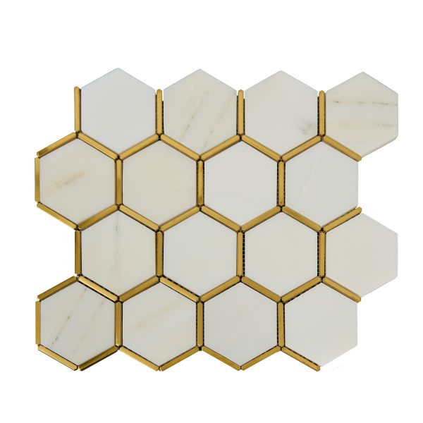 White marble hexagonal mosaic tiles with brass or gold metal grout lines in honeycomb pattern