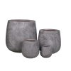 Set of four gray textured concrete round tapered planter pots in graduated sizes