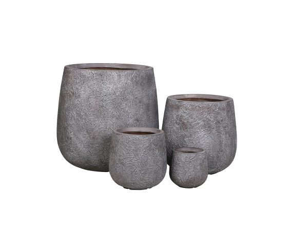 Set of four gray textured concrete round tapered planter pots in graduated sizes