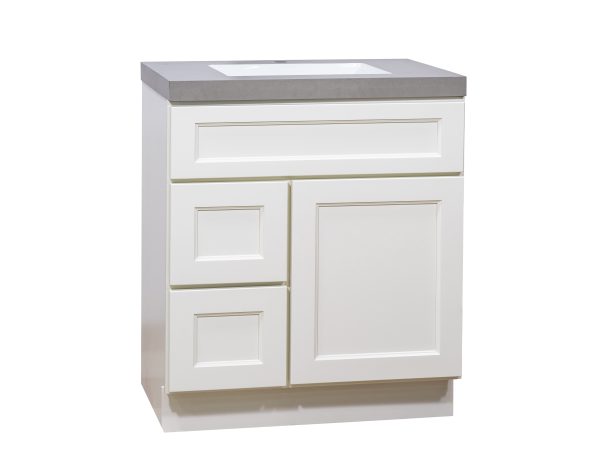 White bathroom vanity with gray countertop featuring one drawer and two cabinet doors in recessed panel design, angled view