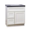 White bathroom vanity with two drawers and one cabinet door, topped with dark gray countertop and white rectangular sink