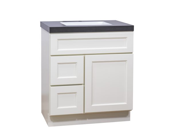 White bathroom vanity with two drawers and one cabinet door, topped with dark gray countertop and white rectangular sink