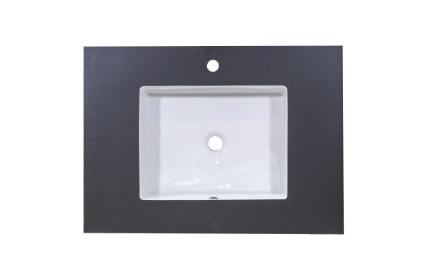 White rectangular bathroom sink with single faucet hole set in dark gray countertop