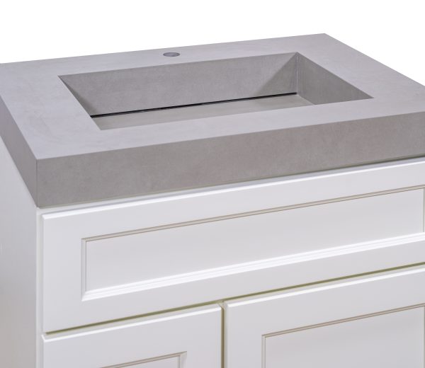 Gray concrete rectangular vessel sink top view with single faucet hole on white vanity cabinet base