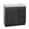 Black bathroom vanity cabinet with white sink top, two doors, one drawer, and three side drawers with bronze handles