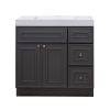 Dark gray bathroom vanity cabinet with white countertop, featuring center double-door cabinet, large top drawer, and two side drawers with bronze handles
