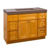 Golden oak bathroom vanity with brown countertop sink, double-door central cabinet, and six surrounding drawers with chrome hardware