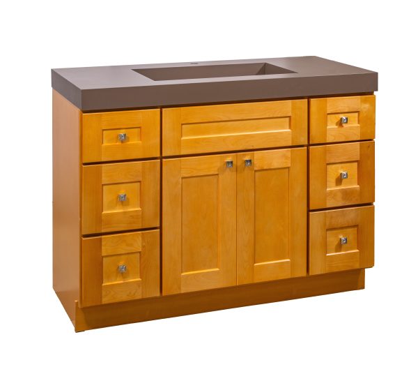 Golden oak bathroom vanity with brown countertop sink, double-door central cabinet, and six surrounding drawers with chrome hardware