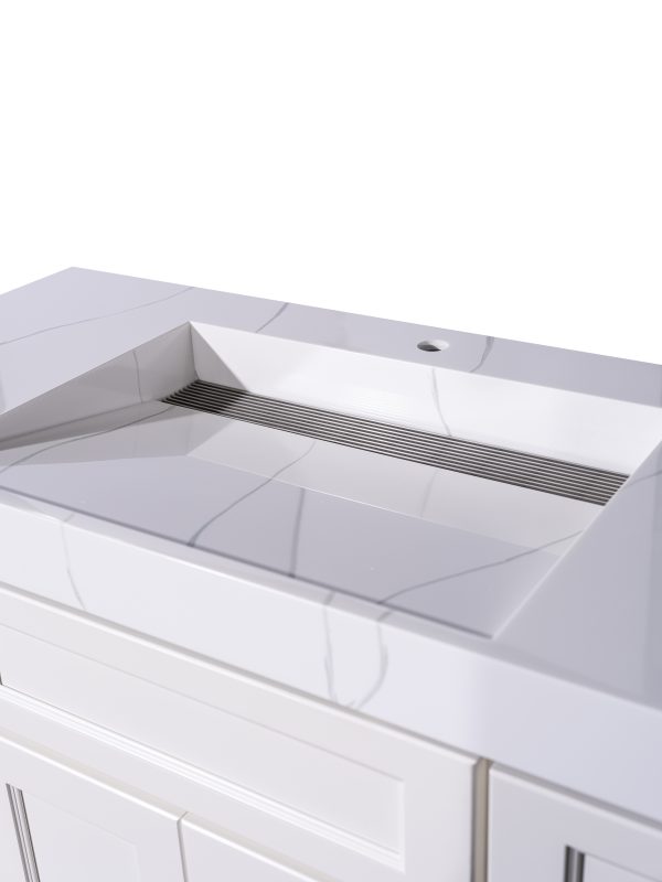 Angled view of white bathroom vanity sink basin with horizontal drain slot detail
