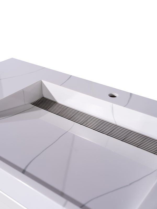 Close-up view of white bathroom vanity sink with parallel drain lines and faucet hole