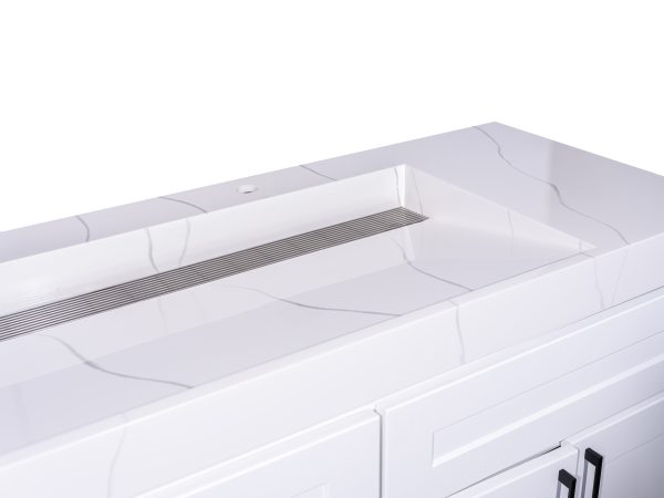 Close-up interior view of white undermount sink with stainless steel drain and curved basin design