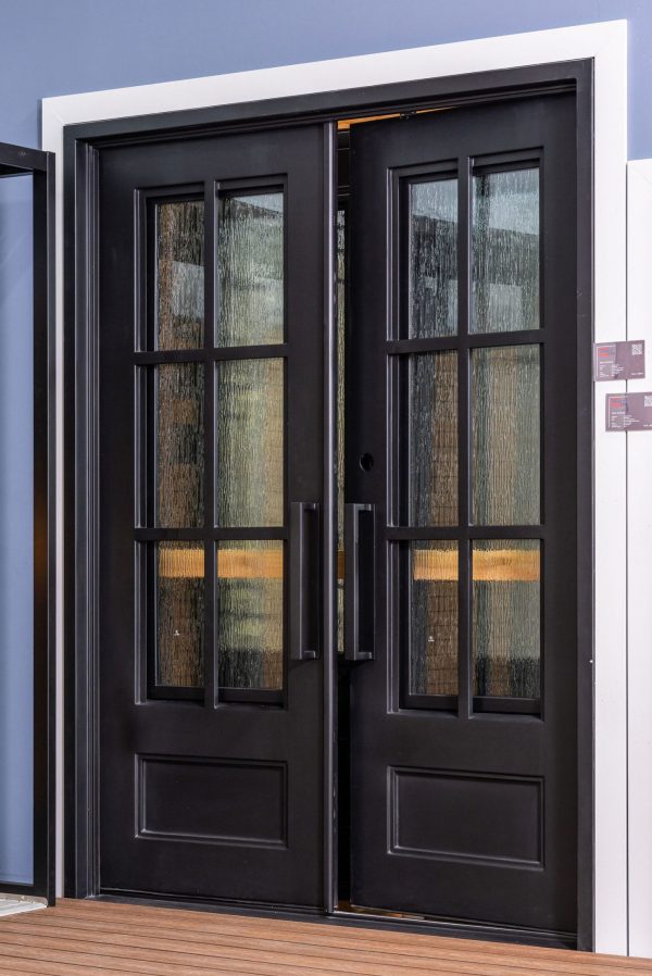 Black double doors with 6-pane grid windows displaying textured glass and wood grain patterns with golden accents