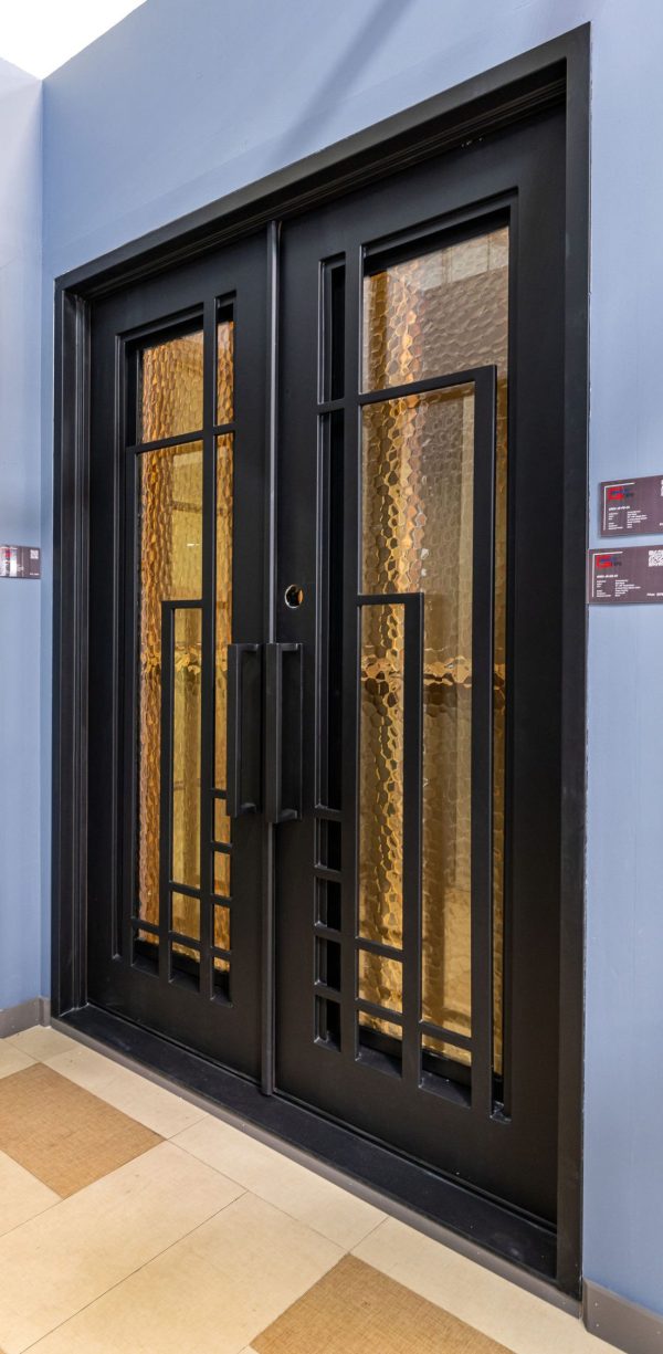 Black double glass doors with geometric grid pattern and gold-tinted glass panels in modern entryway