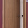 Open wooden interior door with walnut finish and glass panel showing modern minimalist design