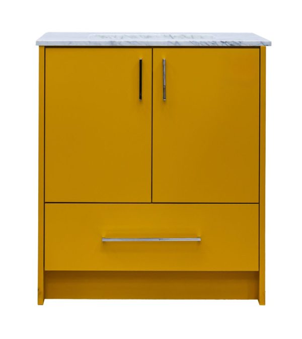 Golden yellow bathroom vanity with white marble countertop, two cabinet doors with black handles, and one drawer
