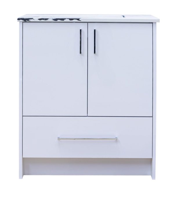 White bathroom vanity cabinet with marble countertop, two cabinet doors with black handles, and one drawer with chrome handle